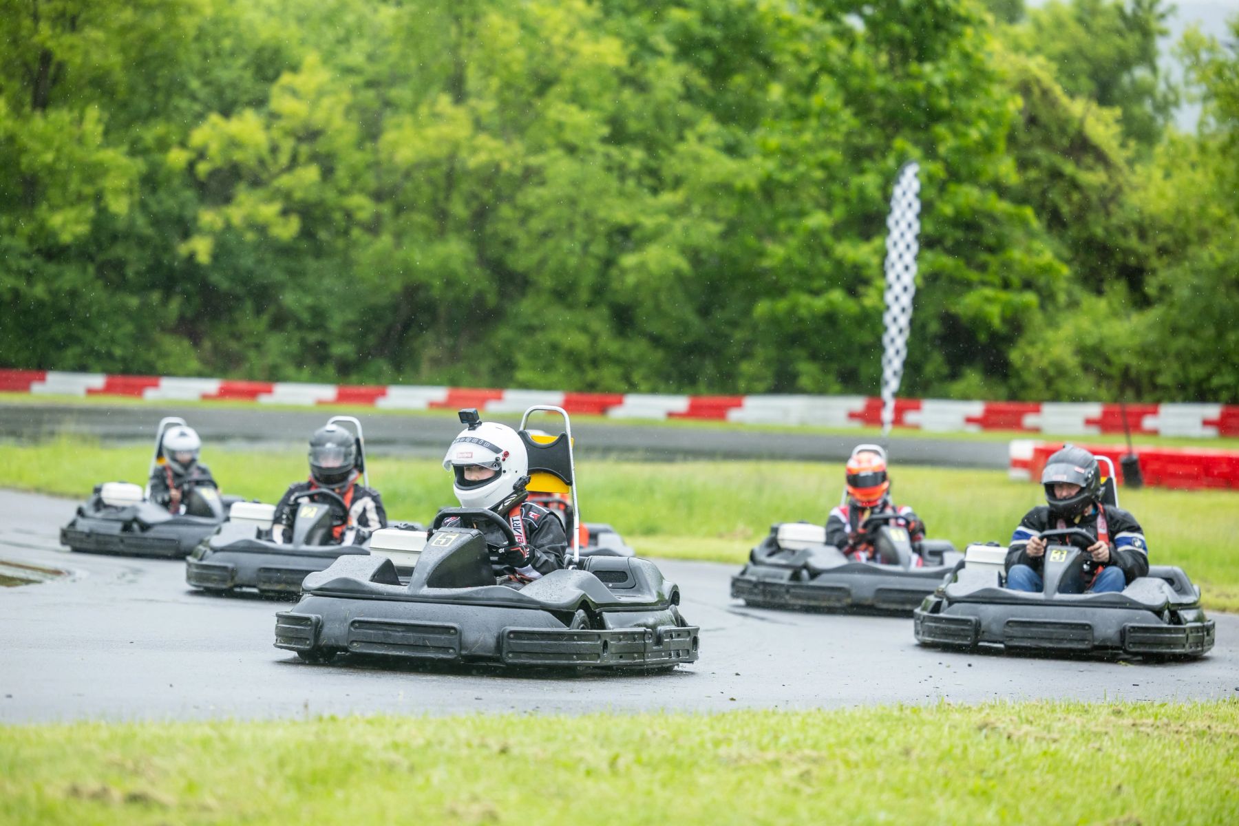 A pack of Arrive & Drive rental karts racing on the LaFayette Motorsports Park track